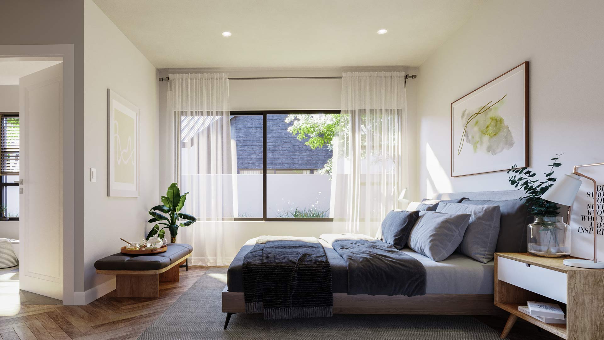 The master bedroom in the free-standing homes with an en-suite bathroom and a large window looking out into the garden