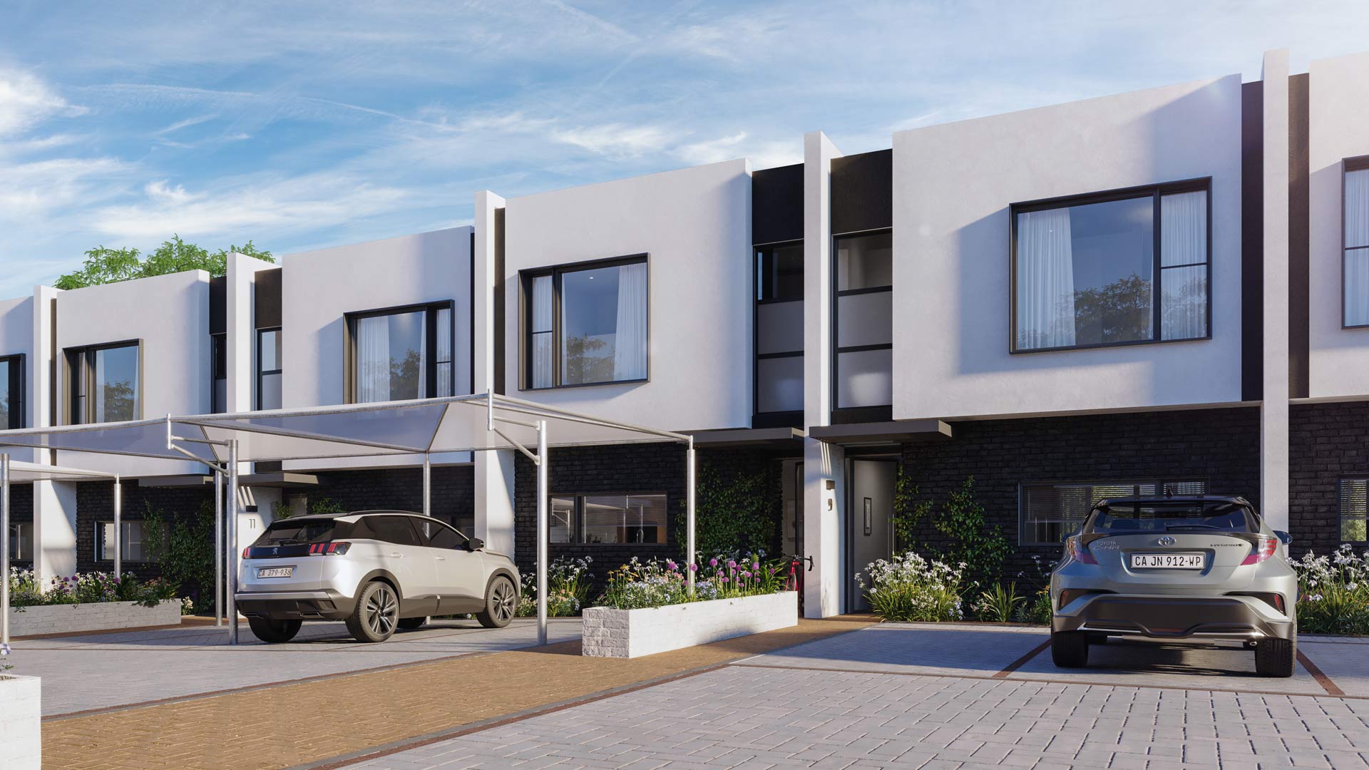 A group of terrace homes with shaded parking and greenery within the secure lifestyle estate